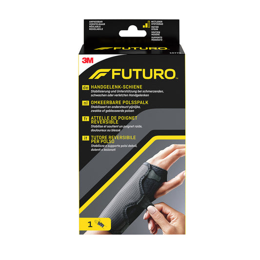 Futuro black reversible wrist brace, adjustable support for wrist stabilization, shown on a person's wrist.