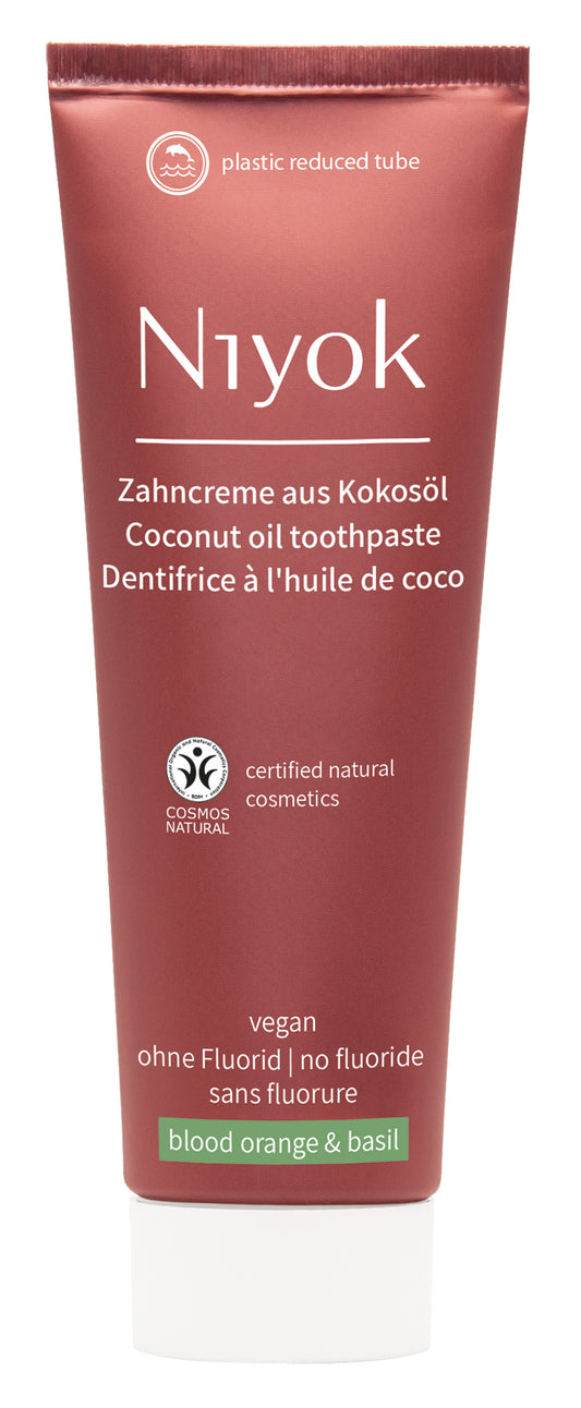 Niyok blood orange basil toothpaste tube, 75ml, featuring vibrant orange and basil flavor packaging.