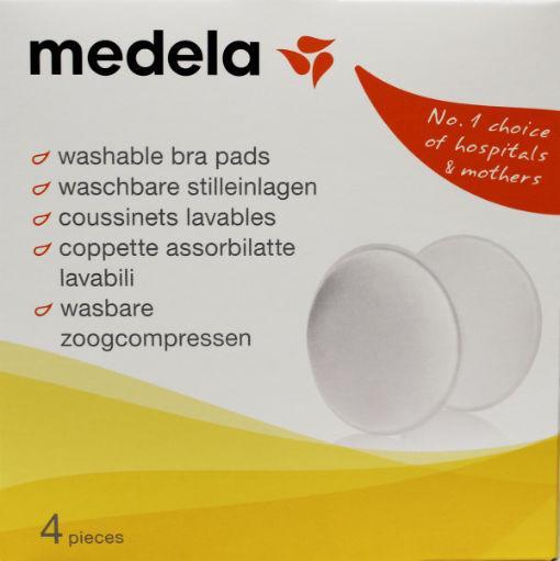 Set of four washable Medela Zoogkompressen for breastfeeding, shown in soft, absorbent fabric.