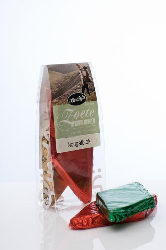 Kindly's Nougatblok verpakt, a pack of two nougat bars, showing creamy texture and chocolate coating in the image.