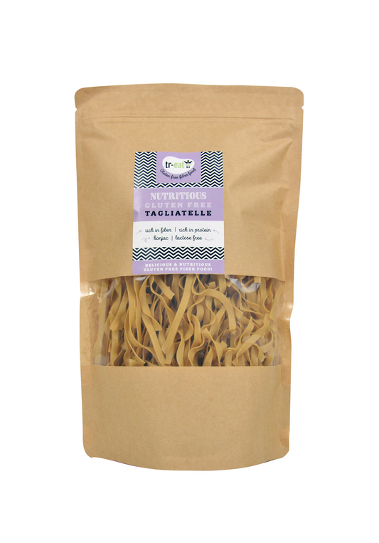 Gluten-free Treat Tagliatelle pasta, 250g, showing uncooked pasta strands in a clear bowl on a white background.
