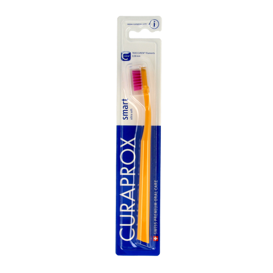 Curaprox CS smart ultra soft toothbrush with white handle and soft bristles, suitable for gentle oral cleaning.