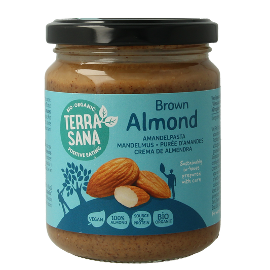 Organic TerraSana almond spread on bread, 250g jar, showcasing the creamy almond paste in a natural setting.