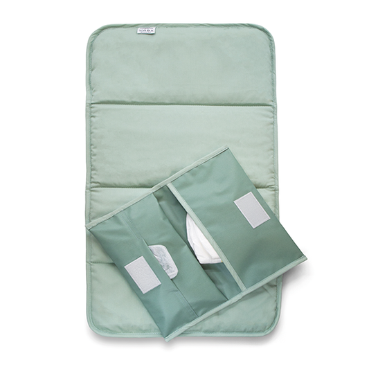 KipKep baby and toddler changing set in pale green, including a changing pad and accessories for baby care.