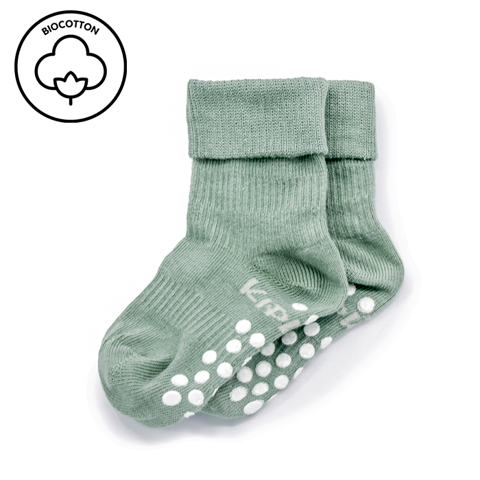 Pale green KipKep Blijf baby socks with anti-slip soles for 12-18 months, showing soft fabric and grip features.