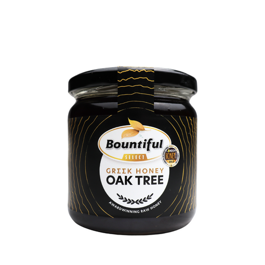 Bountiful Select Greek raw honey from oak tree, 500g jar, natural golden honey with textured honeycomb and wooden spoon.