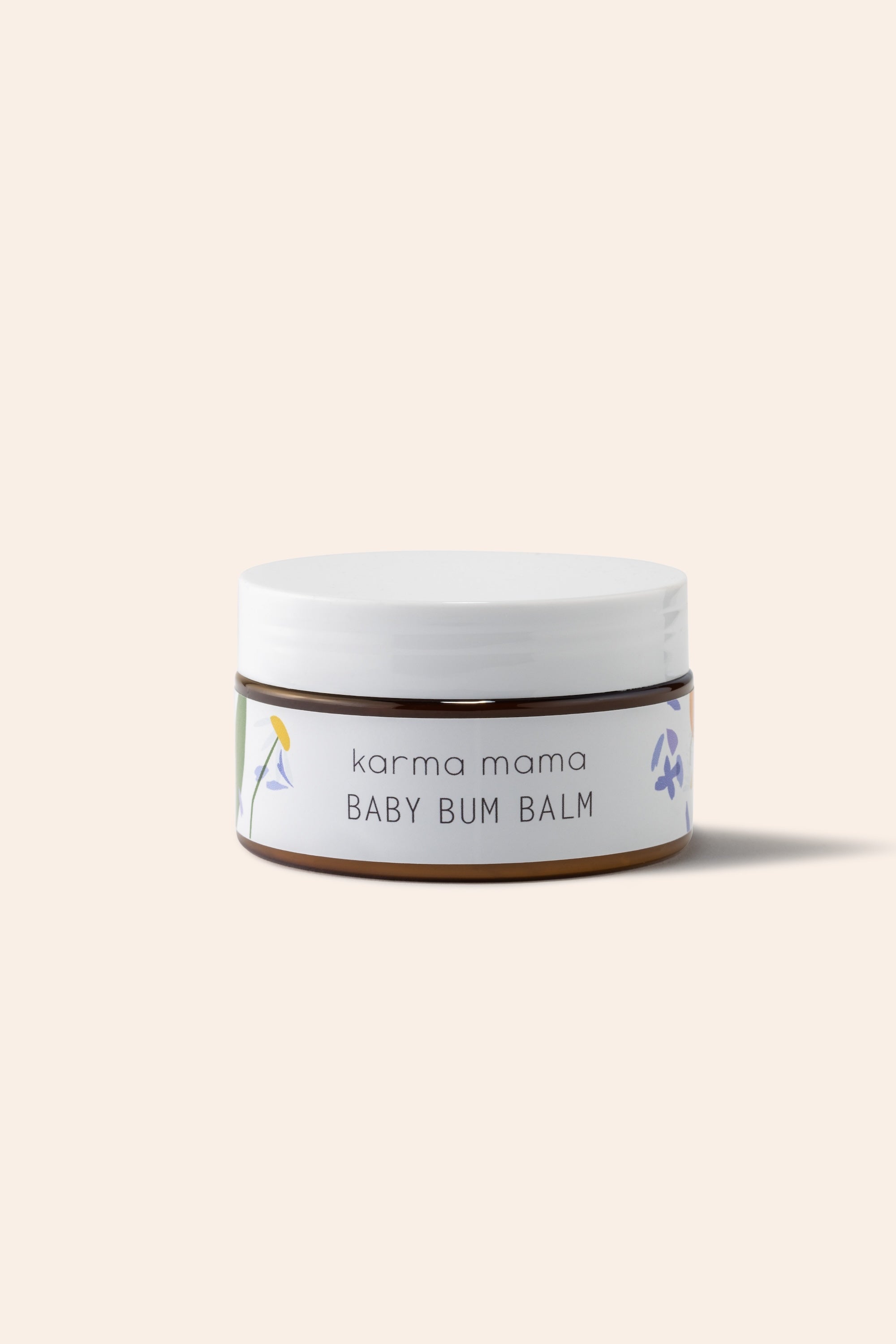 Karma Mama Baby Bum Balm 100ml jar with white lid, gentle skincare for babies and toddlers in a natural setting