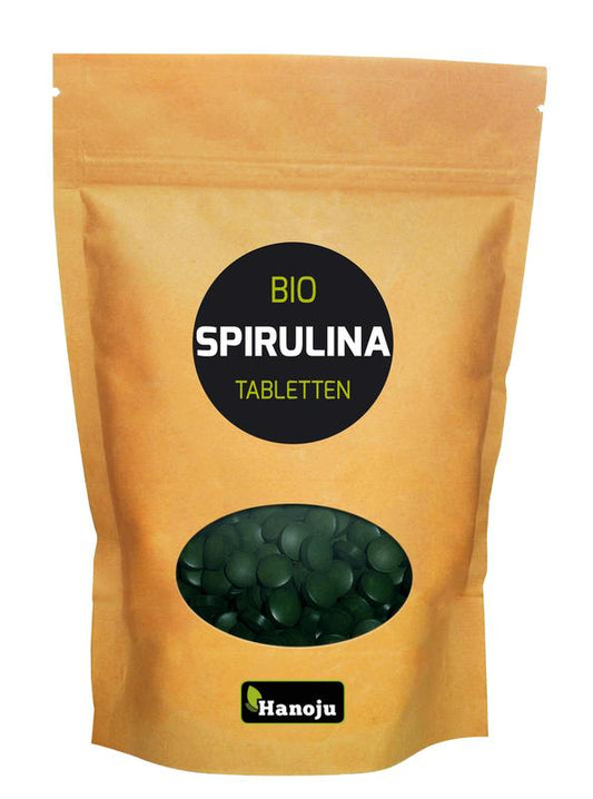 Hanoju Bio spirulina tablets, natural green dietary supplement in a clear container, part of herbal preparations.
